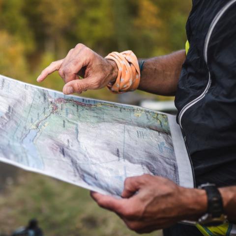 Holding a hiking map while looking at it