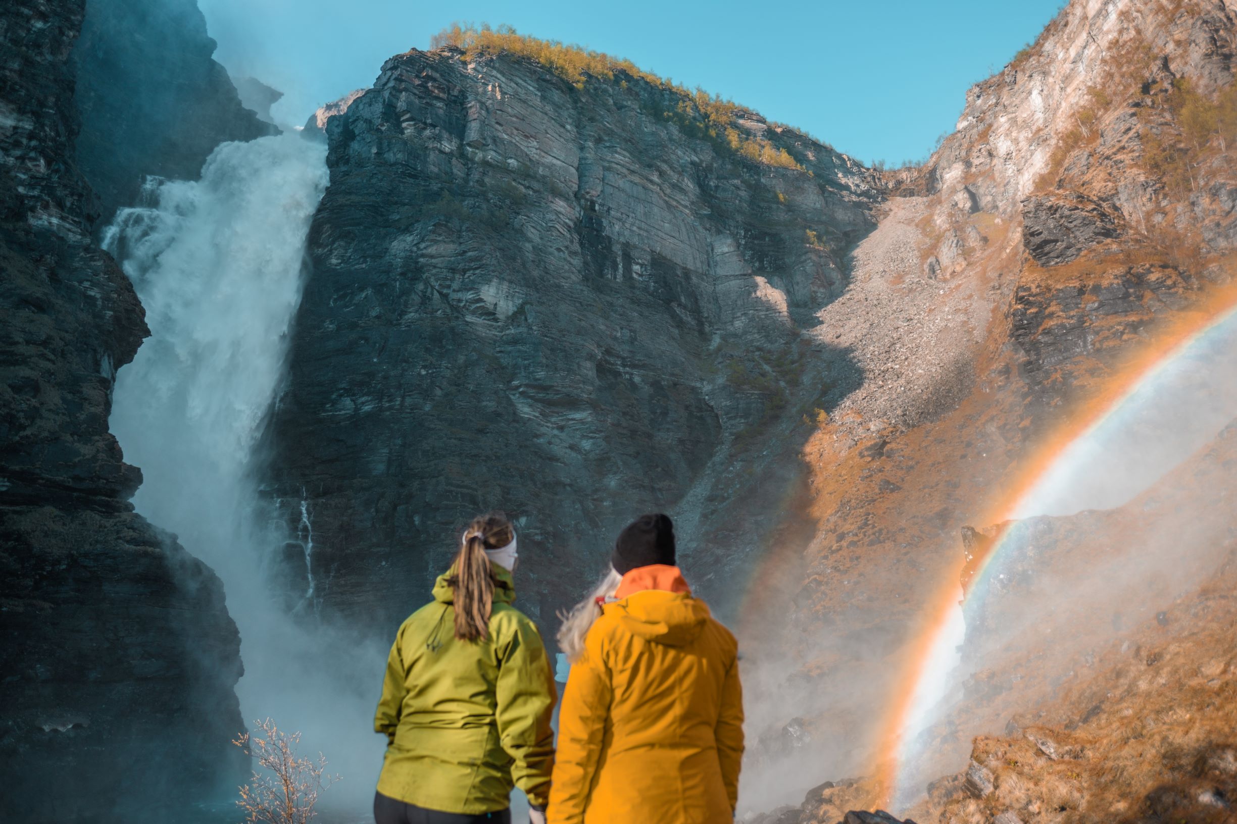 Two people looking at a big waterfall