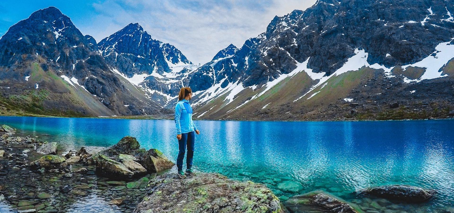 Standing by the Blue lake, enjoying the view of the lake and the Lyngen Alps