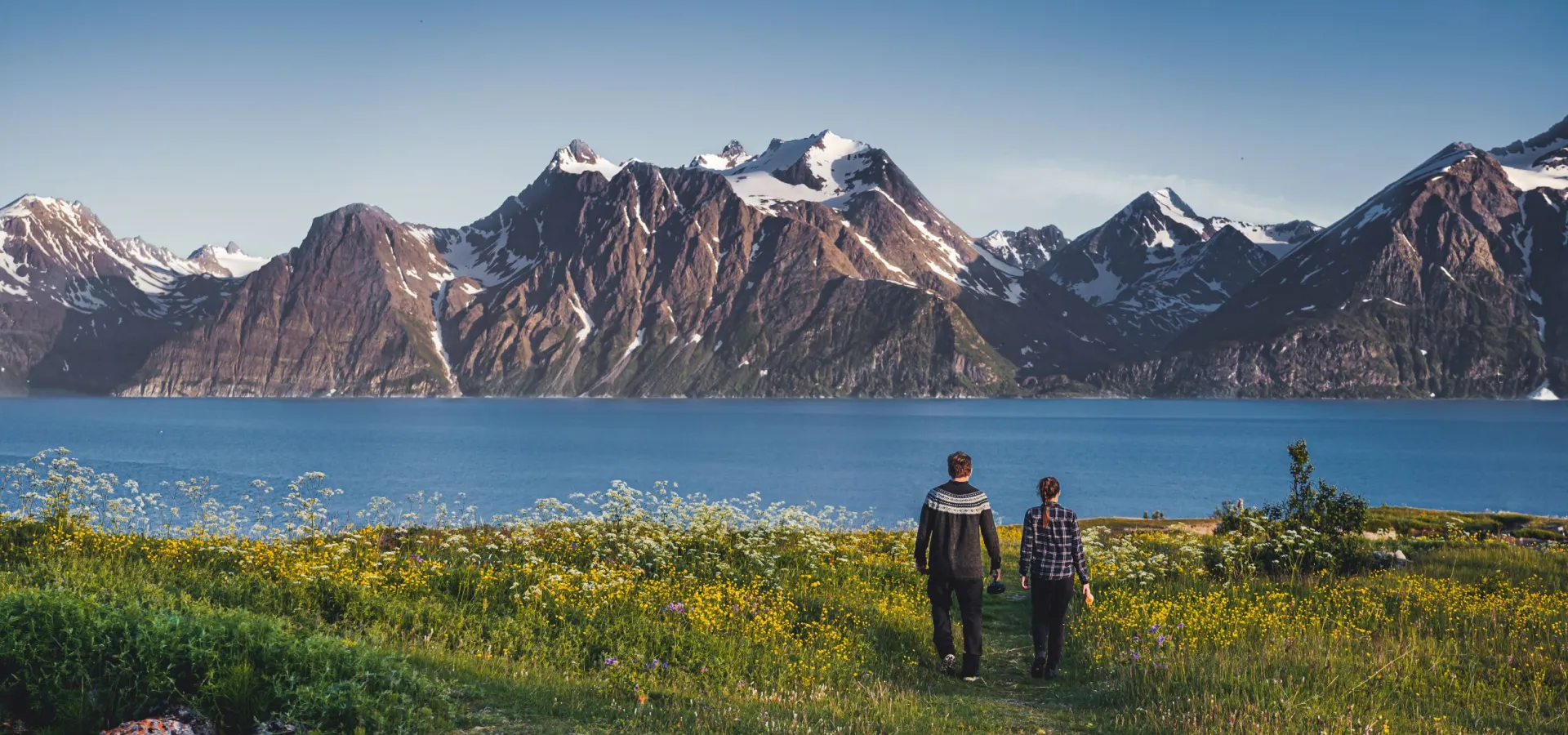 Two persons walking towards the sea at spåkenes.Summer.