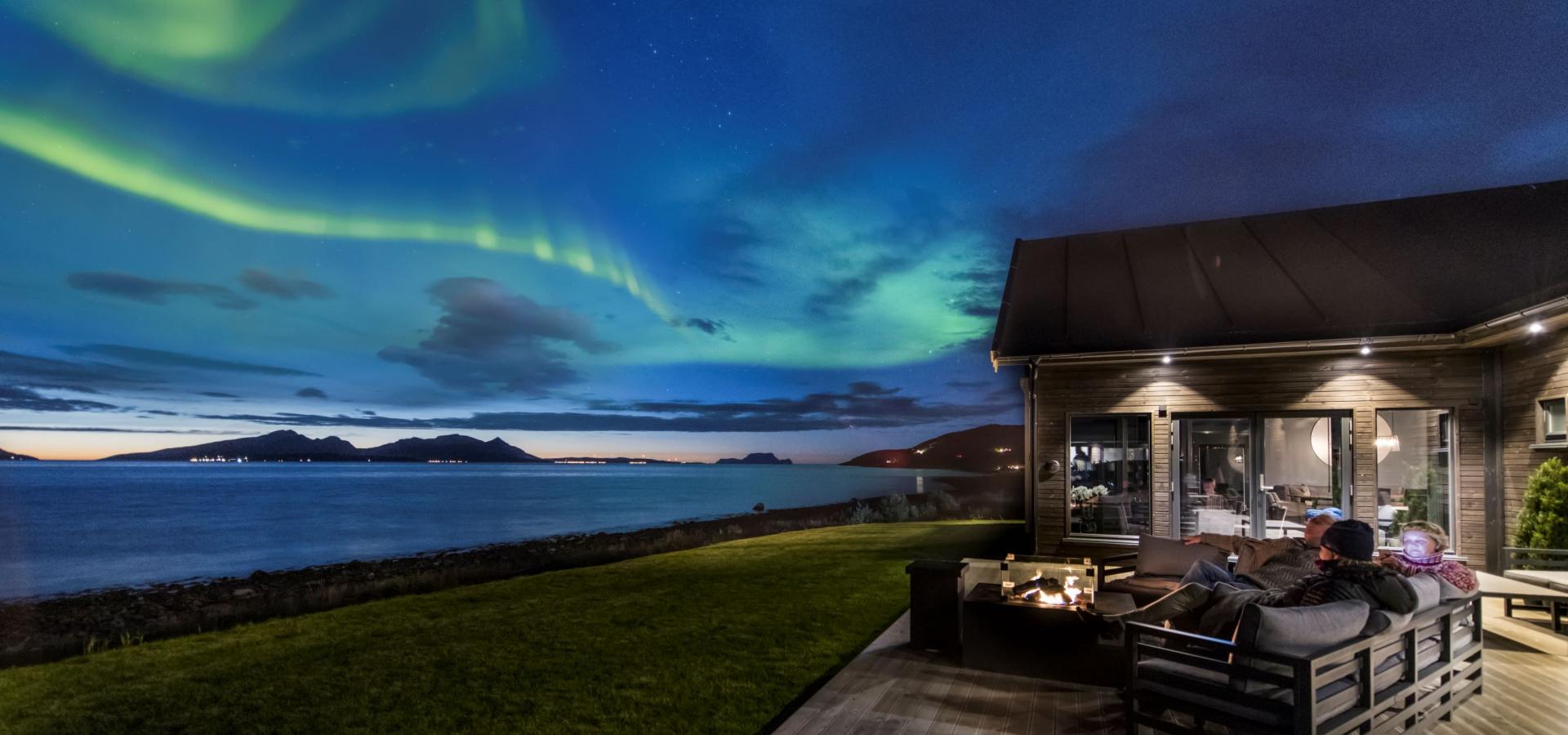 Viewing the northern lights from the terrace at Lyngen Experience Lodge, Northern Norway