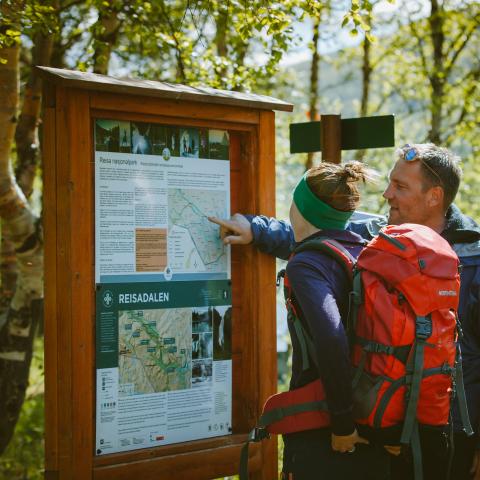 Checking the info bord in Reisa National Park
