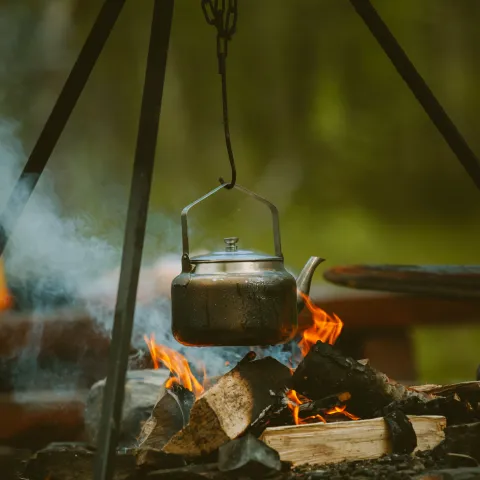 The kettle boiling above the bonfire