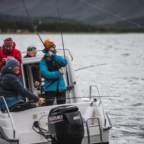 5 persons in a boat trying their luck fishing