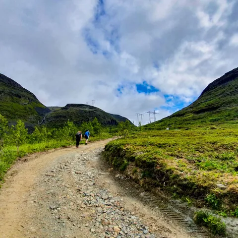 Hiking up a gravel path on a cloudy day
