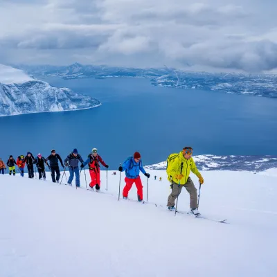 A group of people skiing on a mountain. Walking up.
