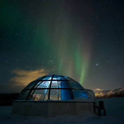 glass igloo under northern lights
