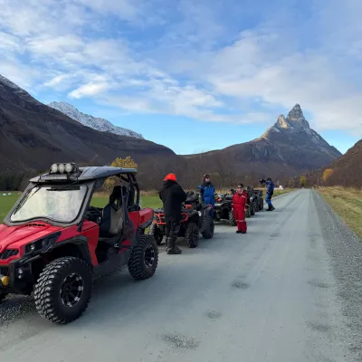 Driving ATV in Signaldalen with mount Otertinden behind them
