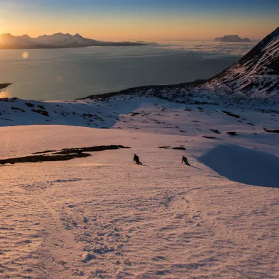 A group of people skiing on a mountain. Walking up.