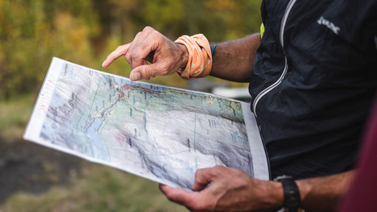 Holding a hiking map while looking at it