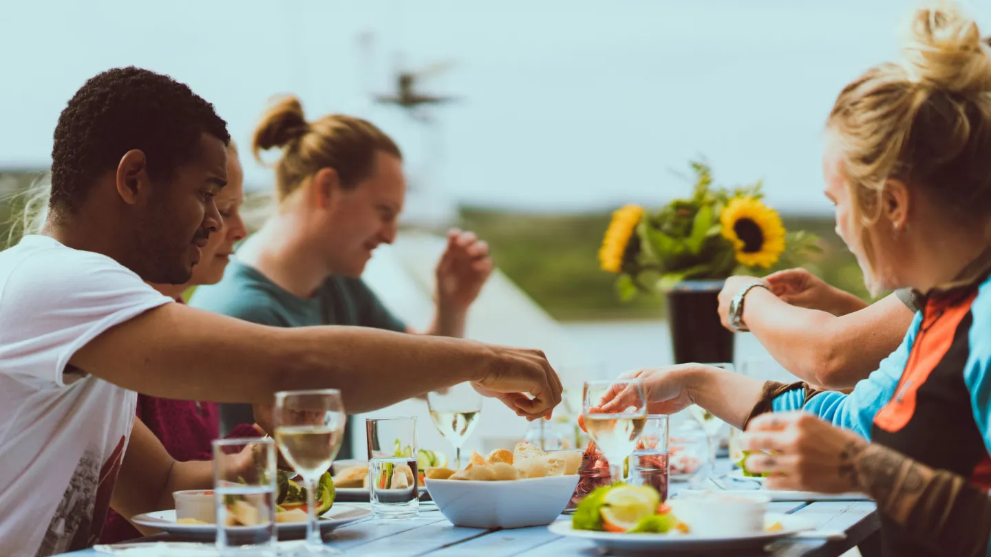 Summer day eating local food with friends around a table
