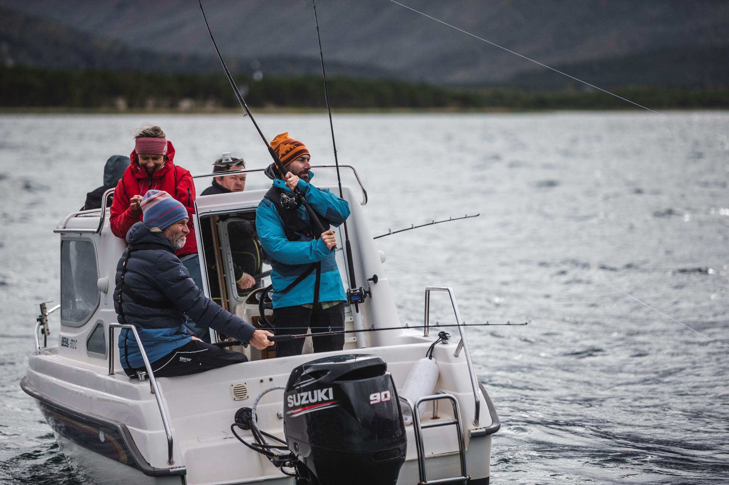 5 persons in a boat trying their luck fishing